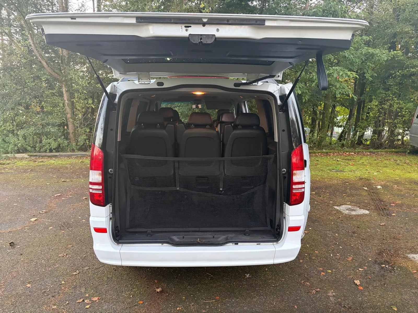 Rear tailgate open, showing the luggage bay and cargo net